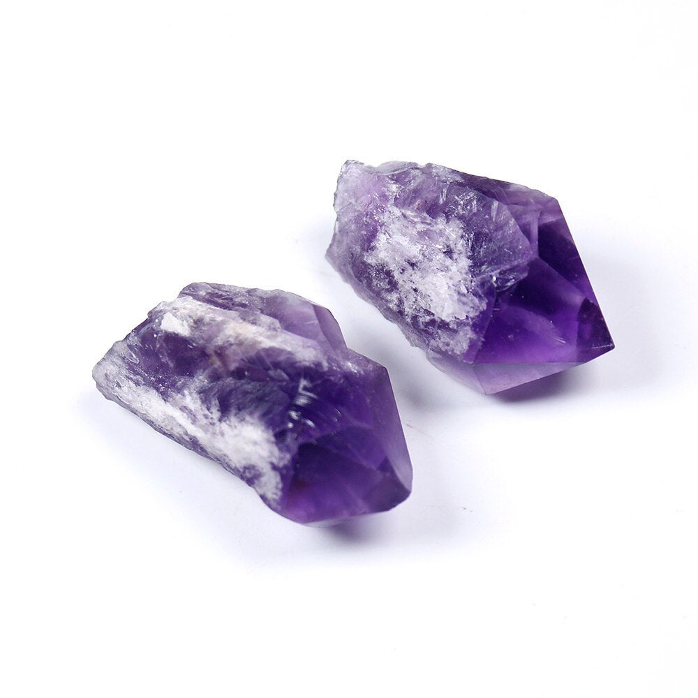 Two amethyst crystal points natural healing stones with purple and white mineral formations
