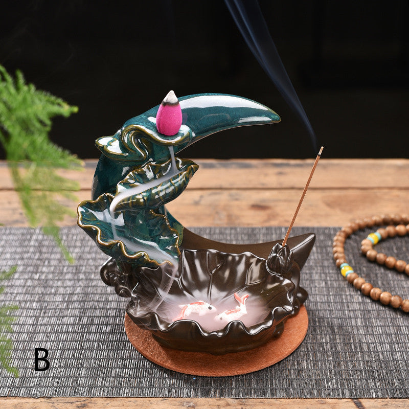 Sacred Moon Candle Co moon backflow incense burner ceramic teal crescent moon with cone and stick holders over koi pool