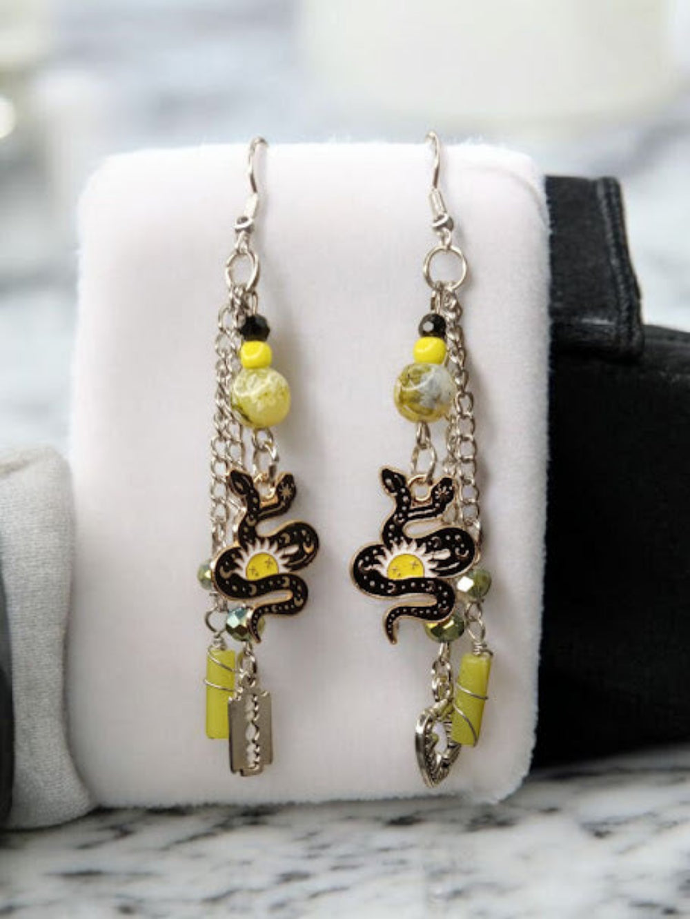 Sacred Moon Candle Co snake charm earrings with yellow beads and silver chains for unique style
