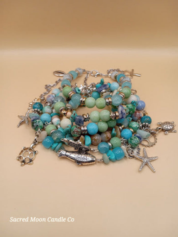 Bohemian beach crystal bracelet stack with turquoise beads and silver sea-themed charms by Sacred Moon Candle Co