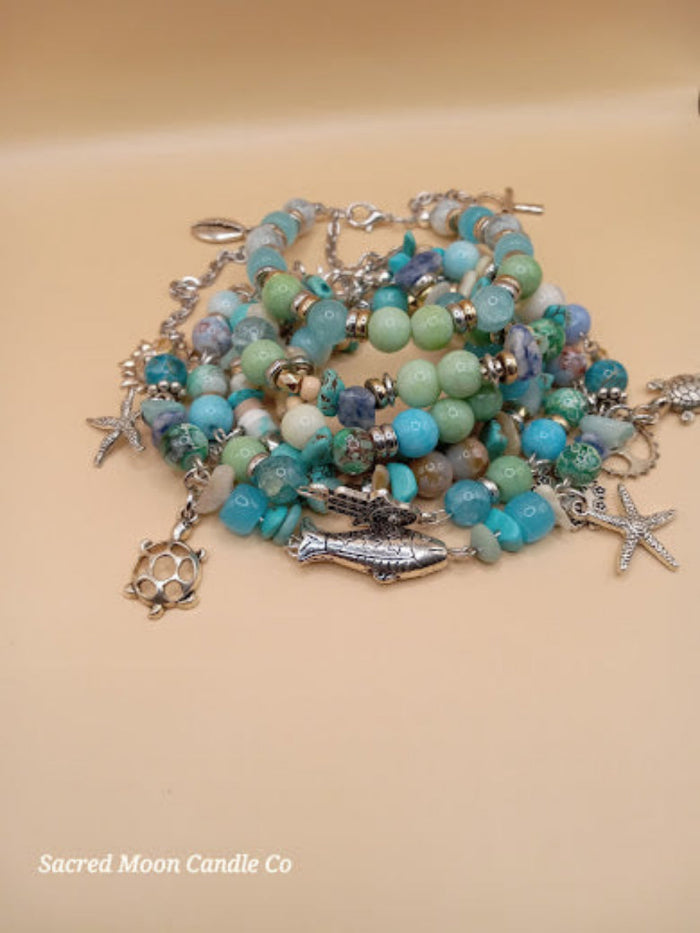Bohemian beach crystal bracelet stack with ocean-colored beads and silver charms by Sacred Moon Candle Co