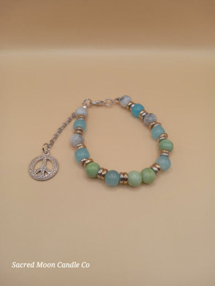 Bohemian beach crystal bracelet stack with blue and green beads and silver peace charm by Sacred Moon Candle Co