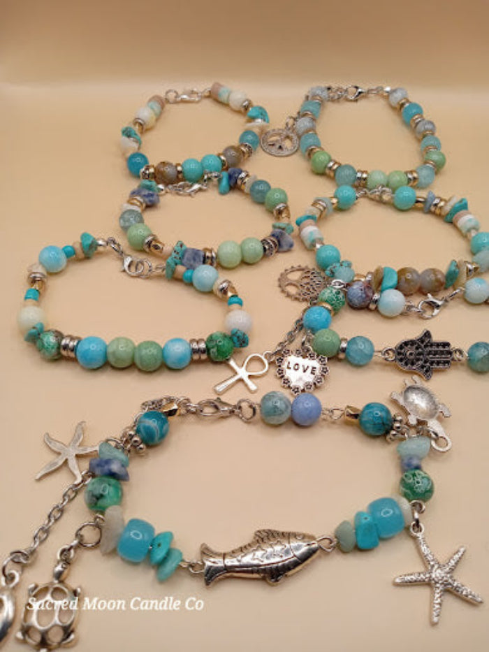 Bohemian beach crystal bracelet stack with turquoise and green beads and silver charms by Sacred Moon Candle Co