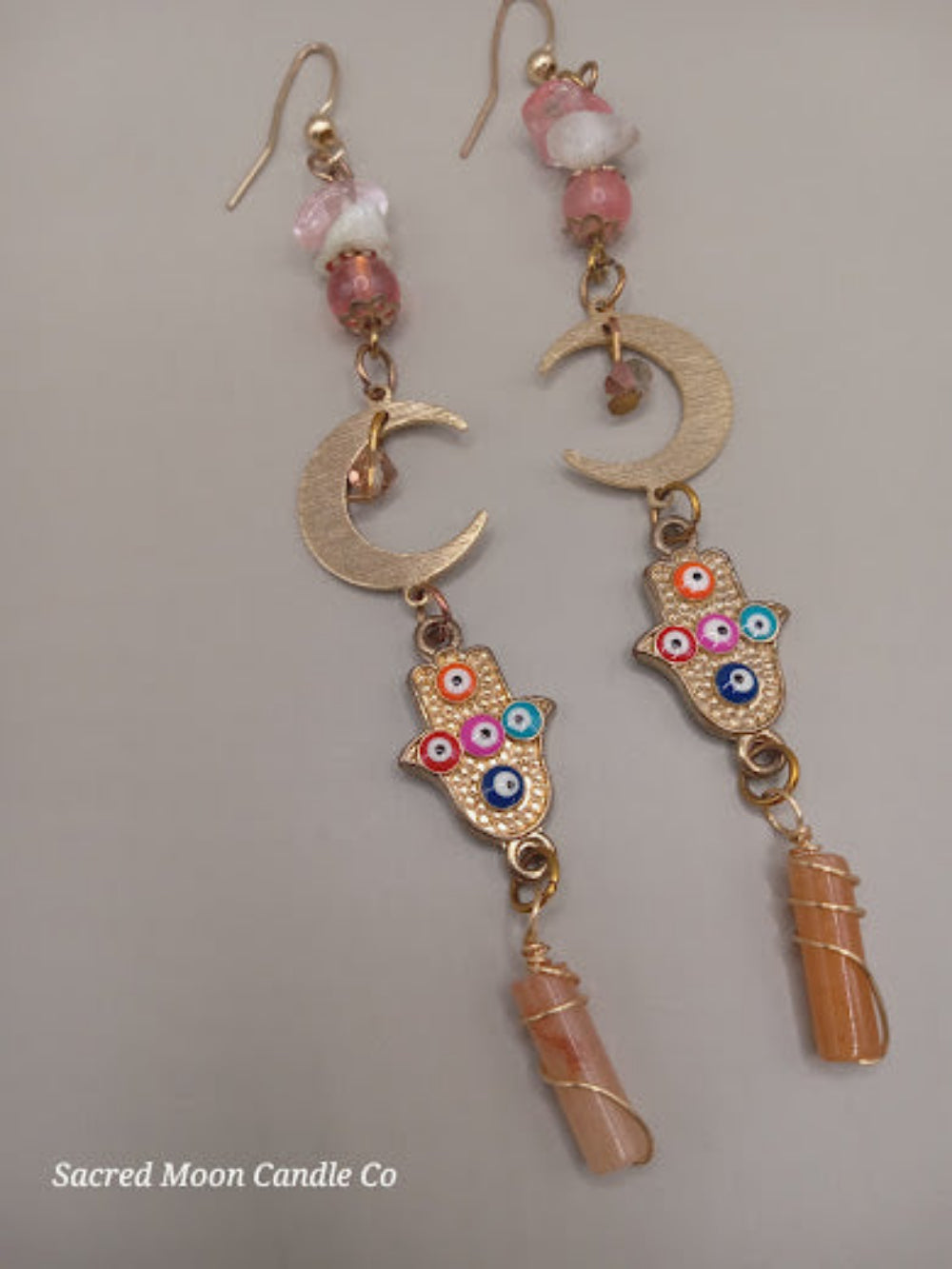 Sacred Moon Candle Co crescent moon hamsa earrings wire wrapped peach aventurine with colorful beads and gold-tone metal