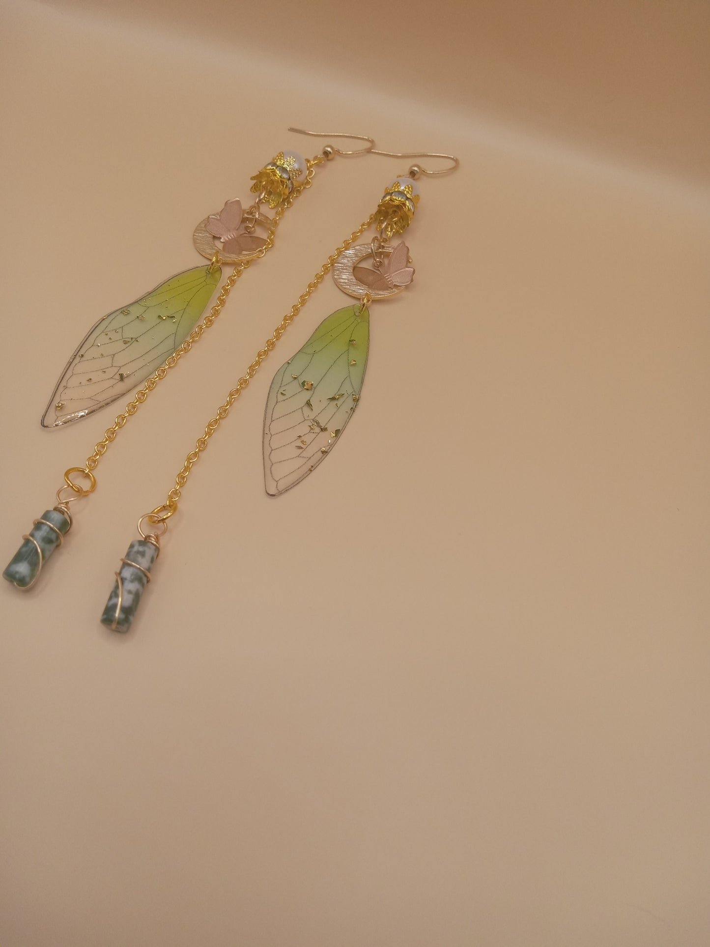 Sacred Moon Candle Co green fairy wing dangle earrings with gold chains pink flower accents and marbled stone drops