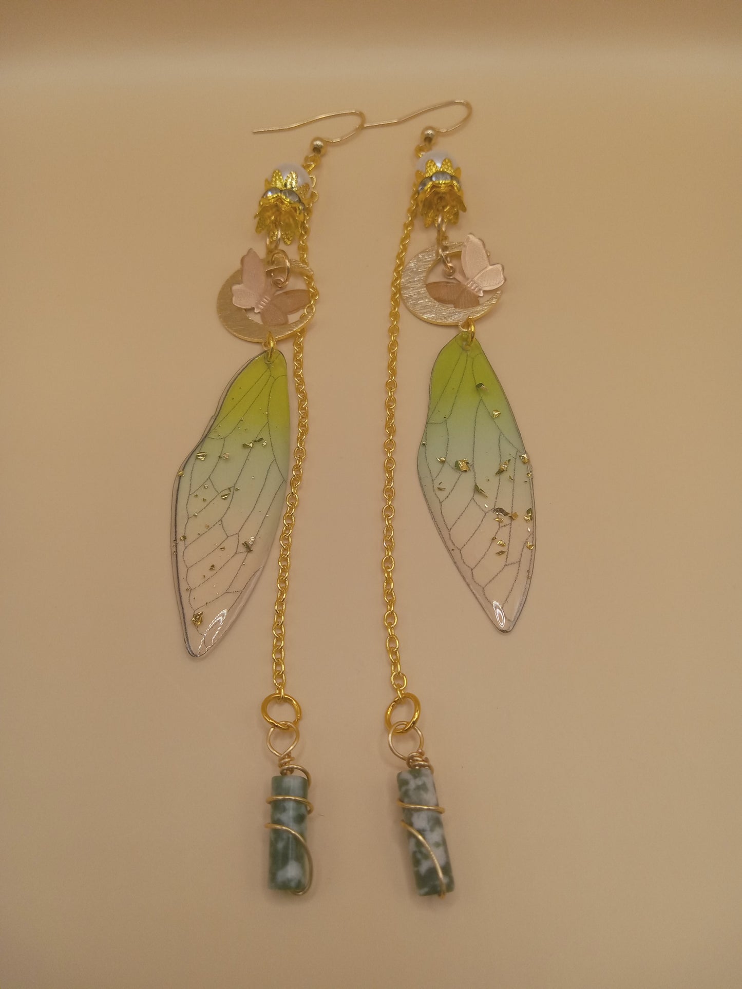 Sacred Moon Candle Co green fairy wing dangle earrings with gold chains, butterfly discs and wrapped green stone