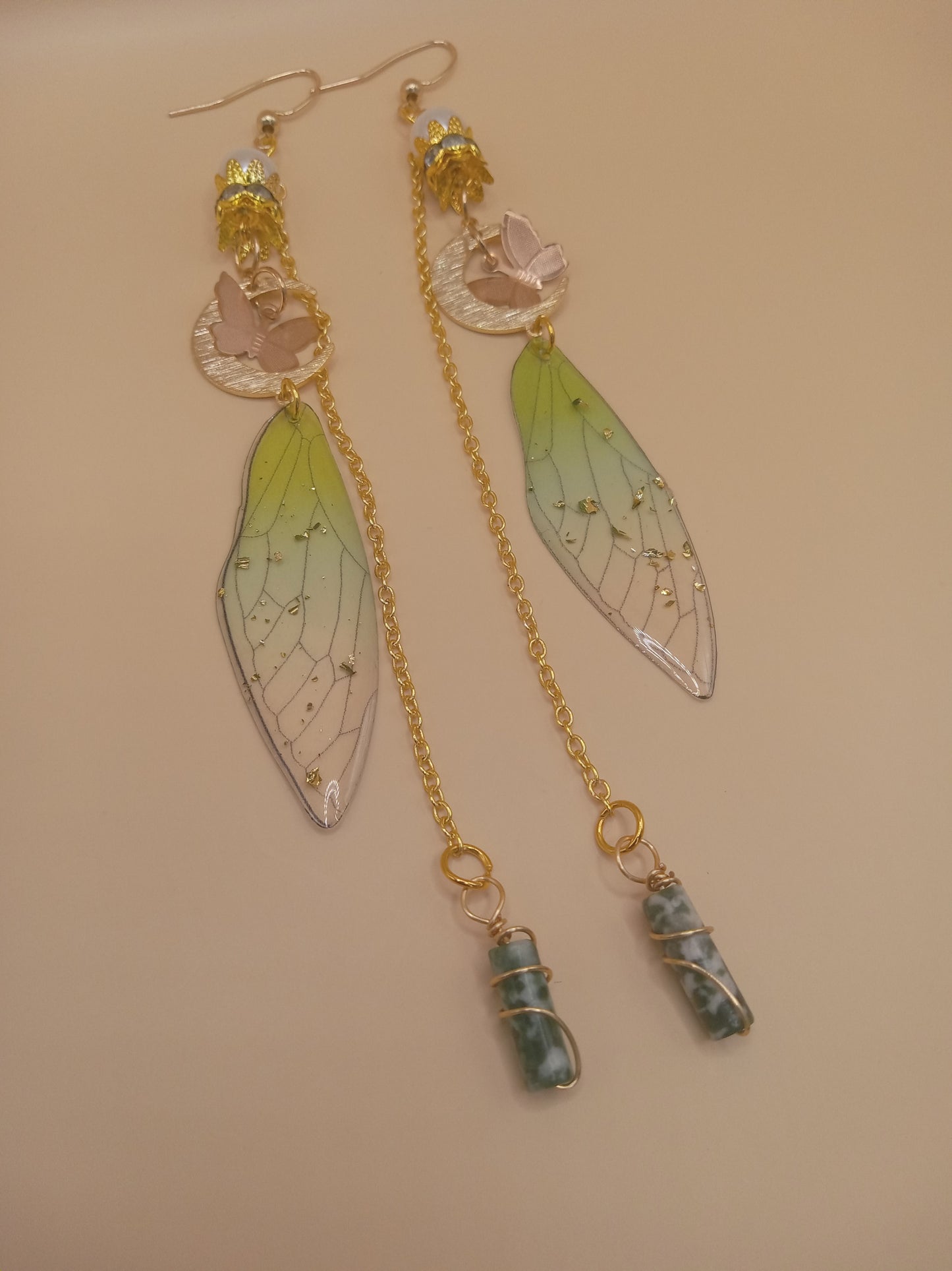 Sacred Moon Candle Co green fairy wing dangle earrings with gold chains crescent moon and wrapped green stone charms
