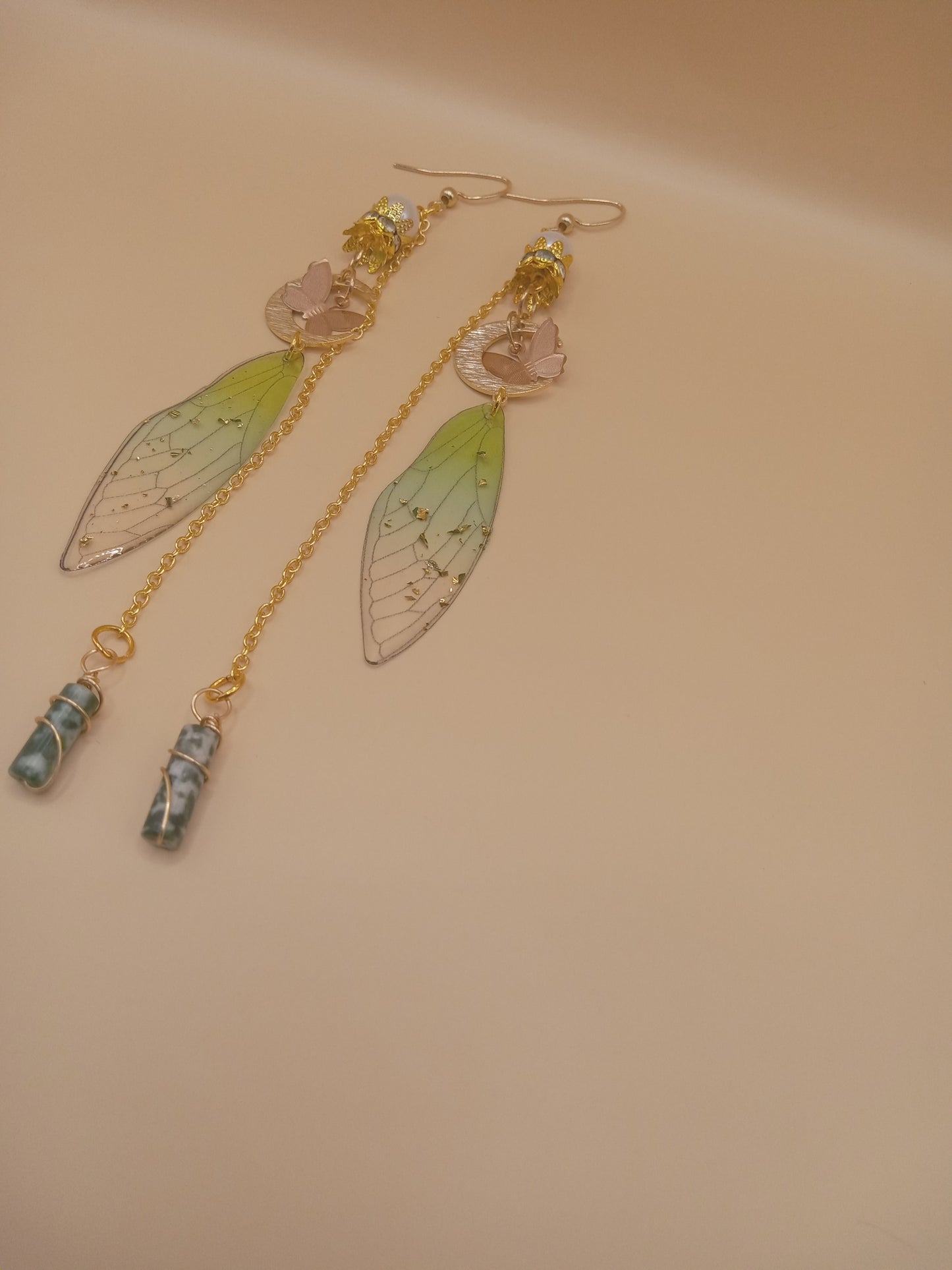 Sacred Moon Candle Co green fairy wing dangle earrings with gold chains moon charms and blue green stone drops