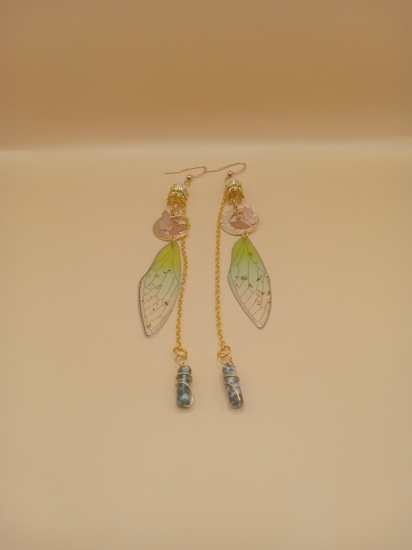 Sacred Moon Candle Co green fairy wing dangle earrings with pink flower accents gold chains and wrapped blue green stone drops