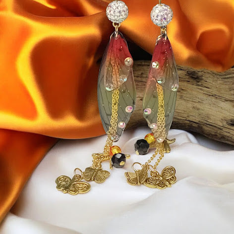 Sacred Moon Candle Co firefly fairy earrings with delicate wing design and gold chain charms