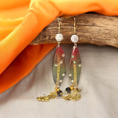 Firefly fairy earrings with colorful translucent wings and gold chain details by Sacred Moon Candle Co