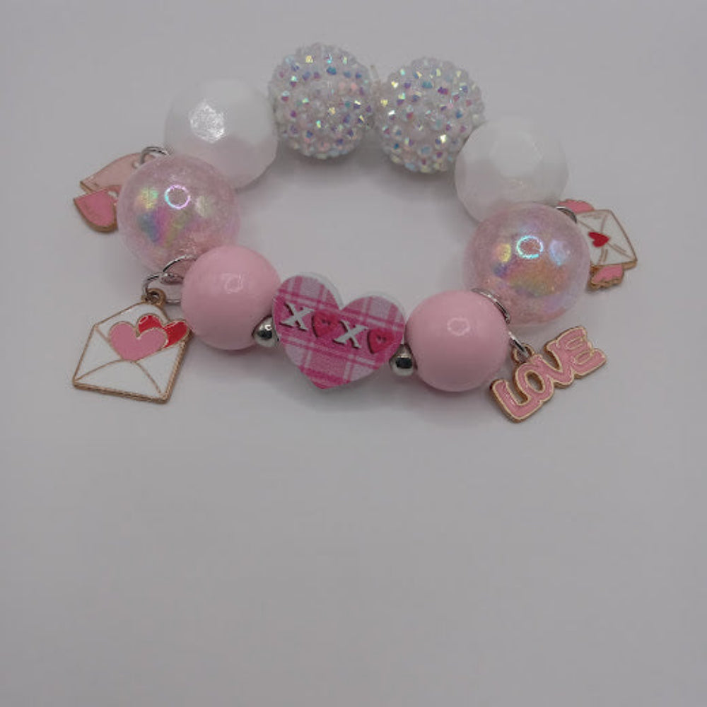 Sacred Moon Candle Co bracelet with pink heart charm and love envelope charms hugs and kisses heart jewelry