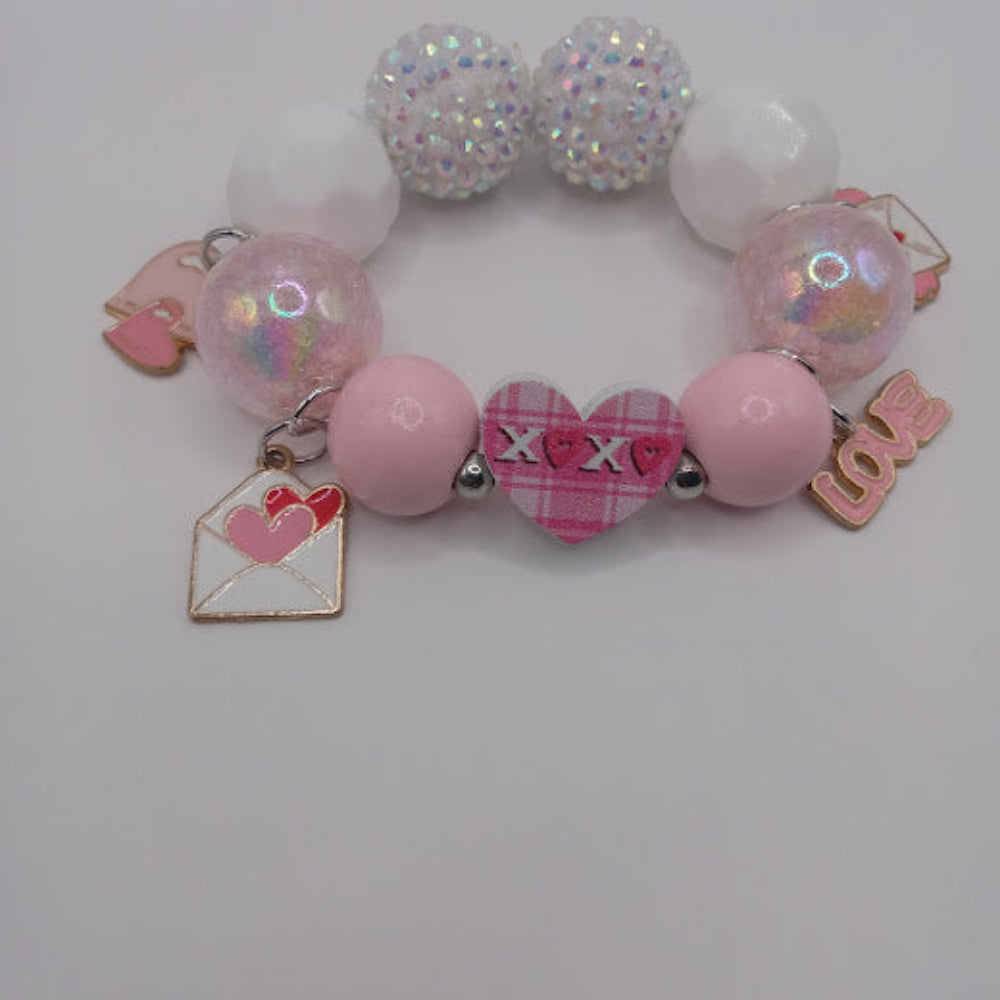 Sacred Moon Candle Co pink and white hugs and kisses heart jewelry bracelet with charm details