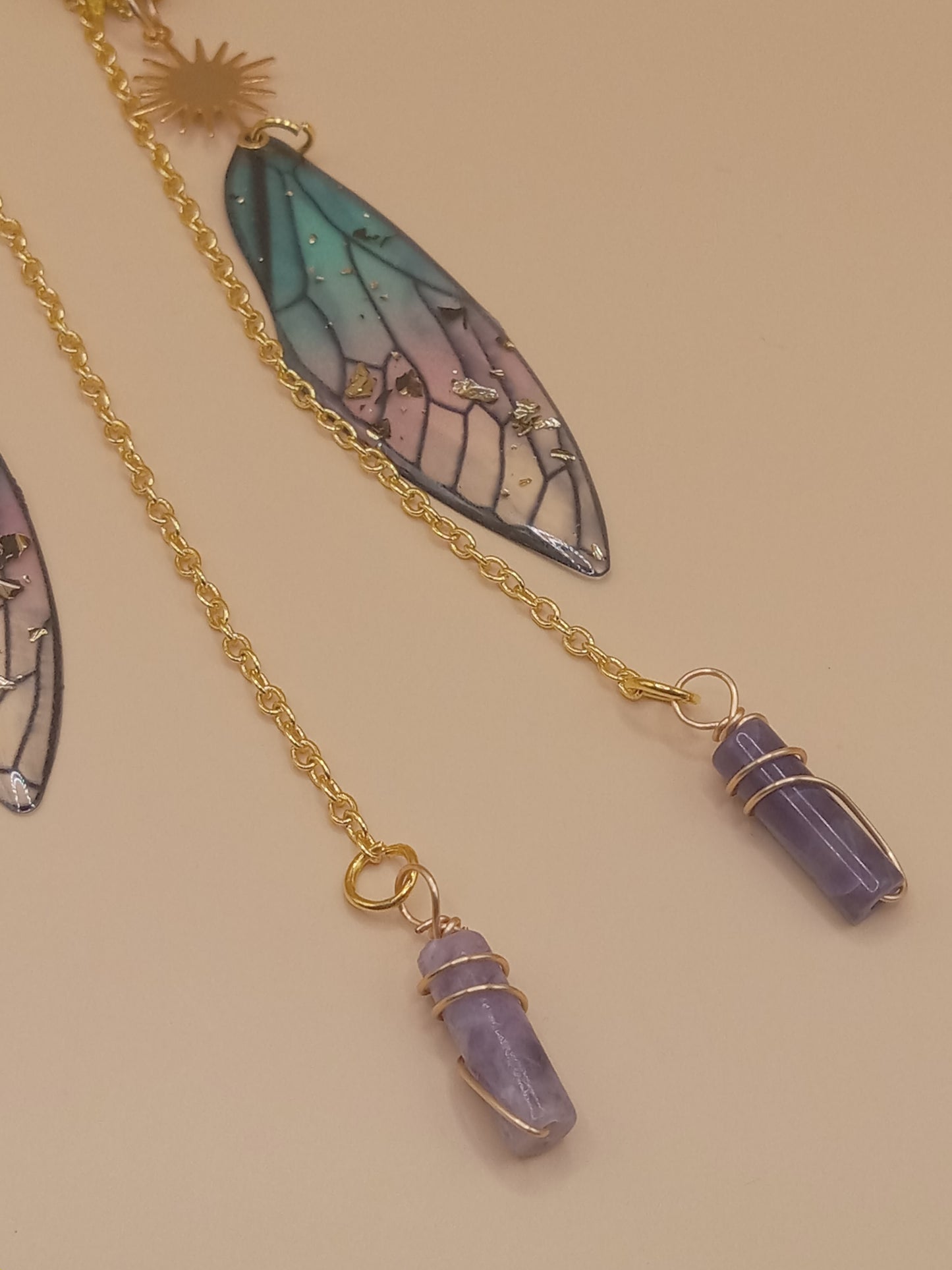Sacred Moon Candle Co blue and violet fairy earrings with gradient wing charm and gold chain amethyst point