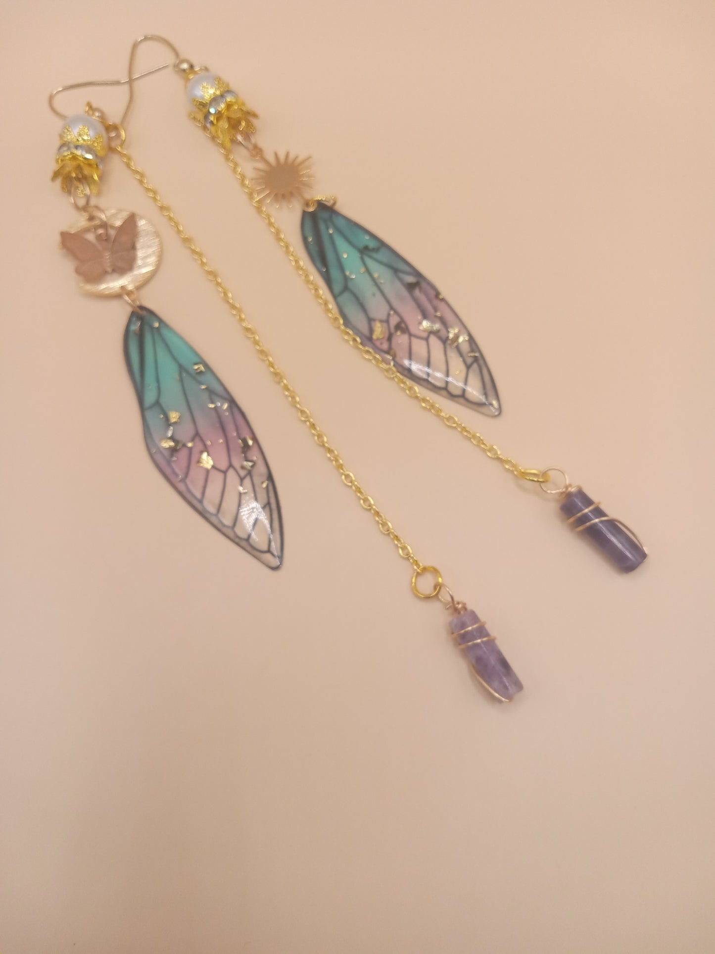 Sacred Moon Candle Co blue and violet fairy earrings with gold chains fairy wing charms and amethyst crystal points