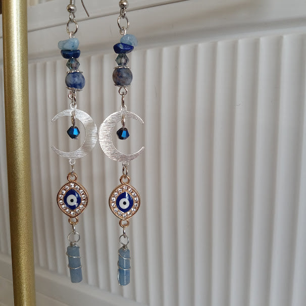 Sacred Moon Candle Co silver crescent moon evil eye earrings with blue beads and dangle stones