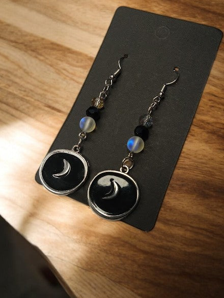 Sacred Moon Candle Co moon medallion earrings with black and silver crescent design and bead accents