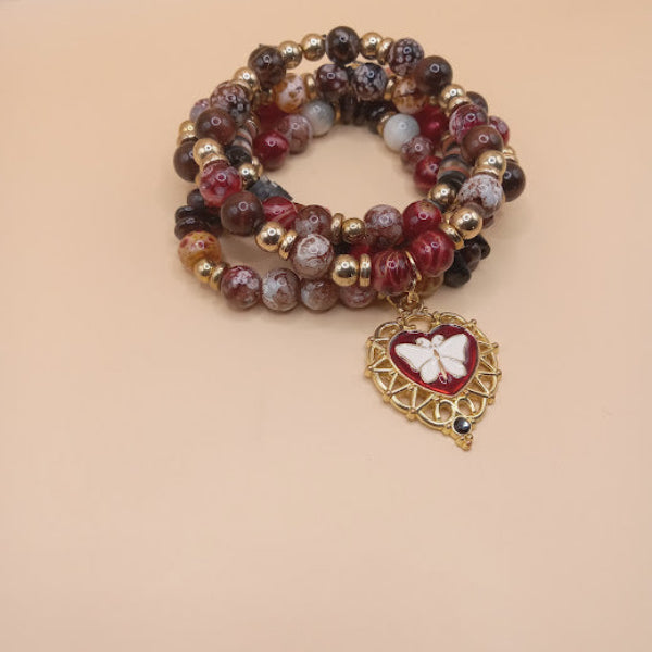 Moth and flame bracelet stack by Sacred Moon Candle Co with red and brown beads and gold heart charm