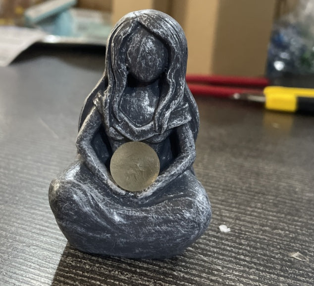 Sacred Moon Candle Co grey resin seated statue of a faceless woman holding a moon disc moon goddess alter figurine .