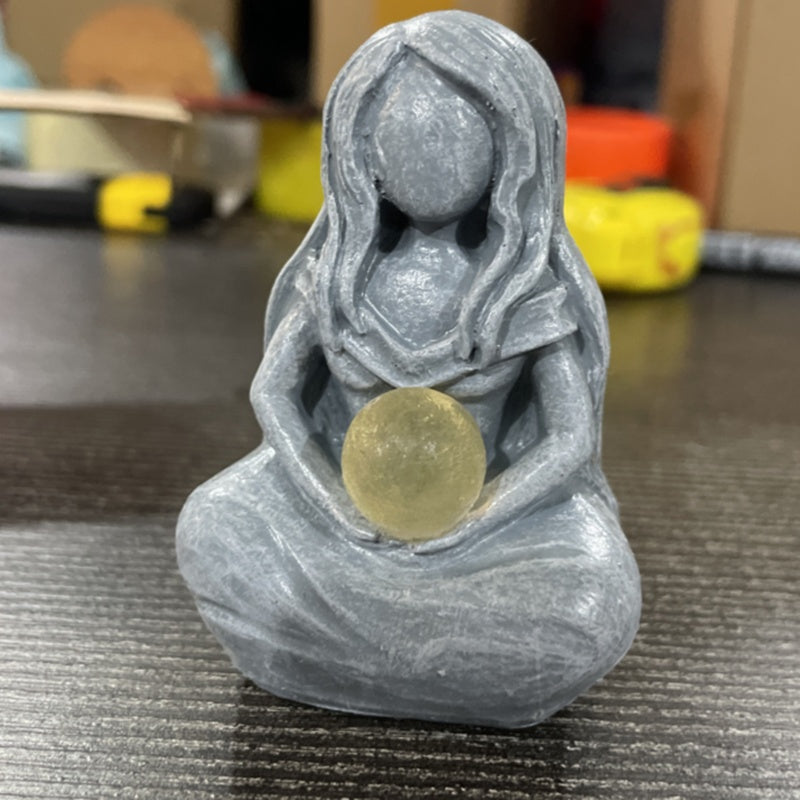 Sacred Moon Candle Co moon goddess alter figurine . Gray seated goddess holding translucent moon orb altar statue