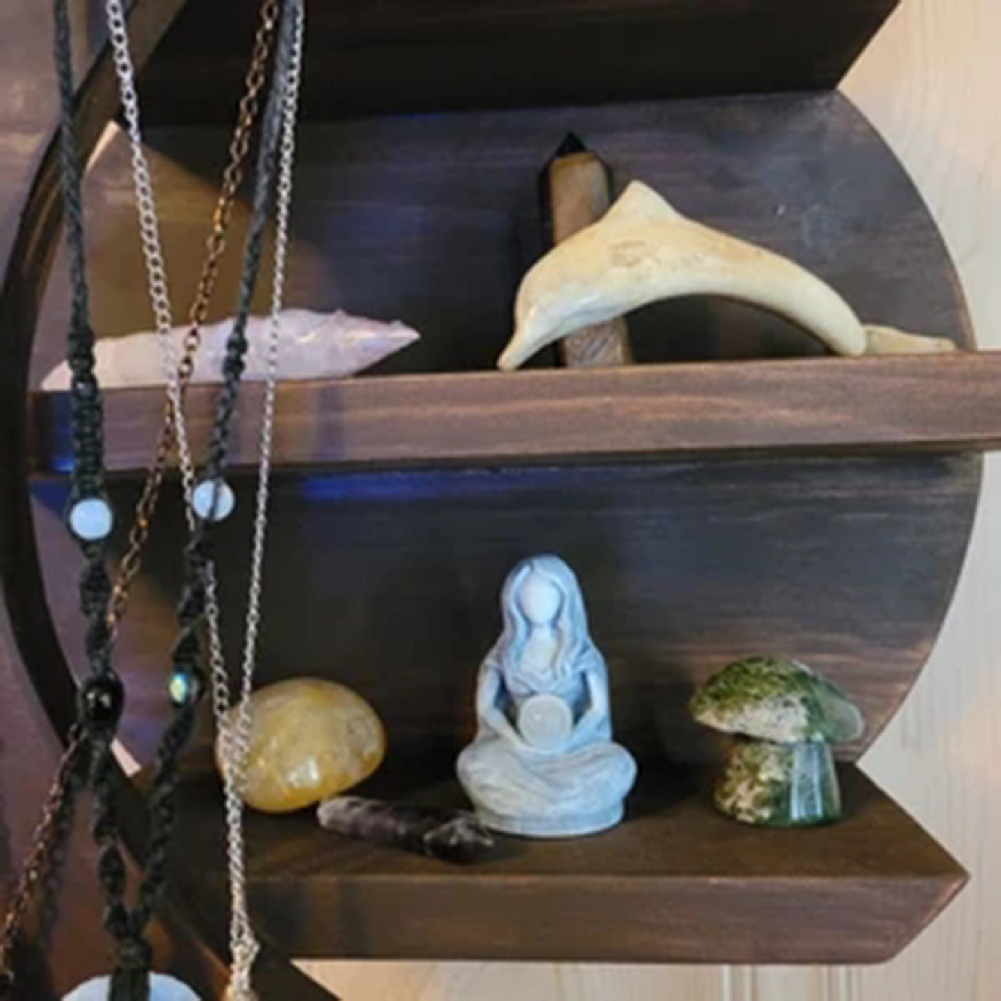 Sacred Moon Candle Co moon goddess alter figurine . Hand carved seated goddess statue on wooden altar shelf with crystals
