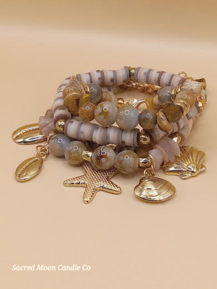Bohemian natural stone bracelet stack with gold seashell charms by Sacred Moon Candle Co