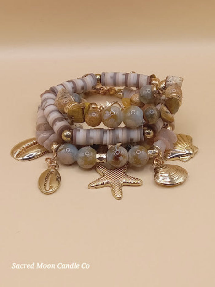 Bohemian natural stone bracelet stack by Sacred Moon Candle Co featuring gold charms and earthy beads