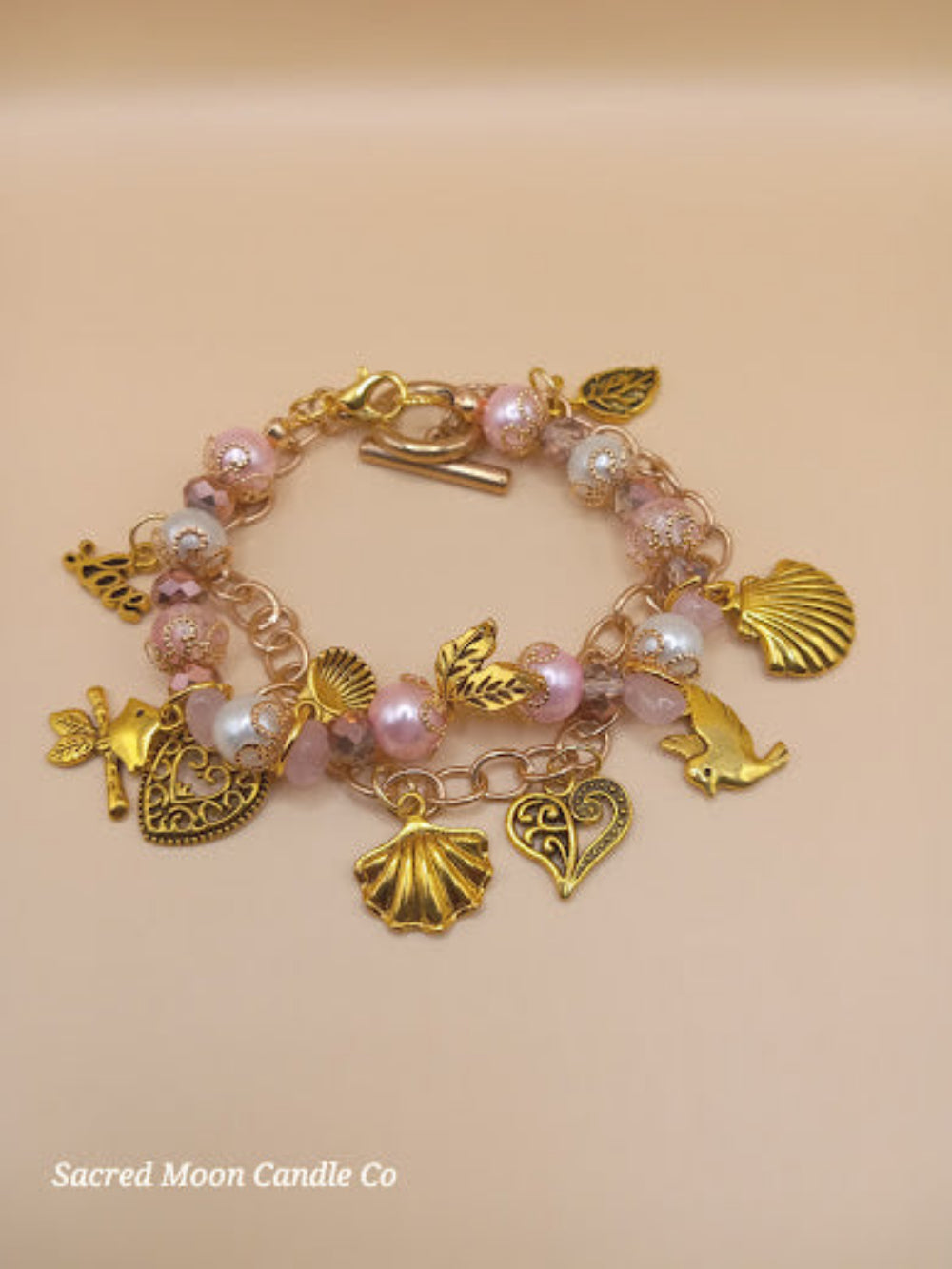 Sacred Moon Candle Co Aphrodite bracelet set with gold charms and pink beads bracelet stack