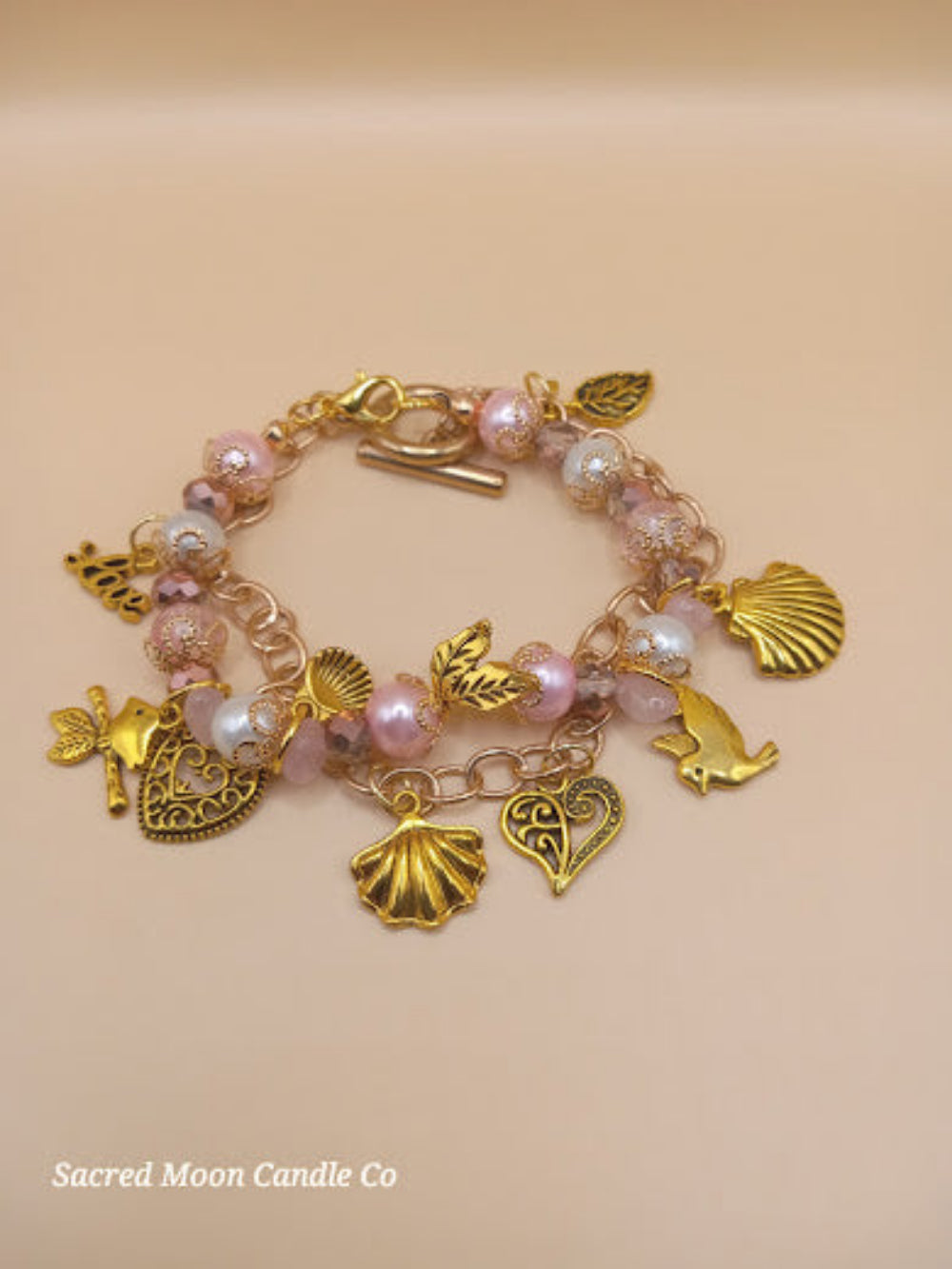 Aphrodite bracelet set from Sacred Moon Candle Co with gold charms and pink pearl beads