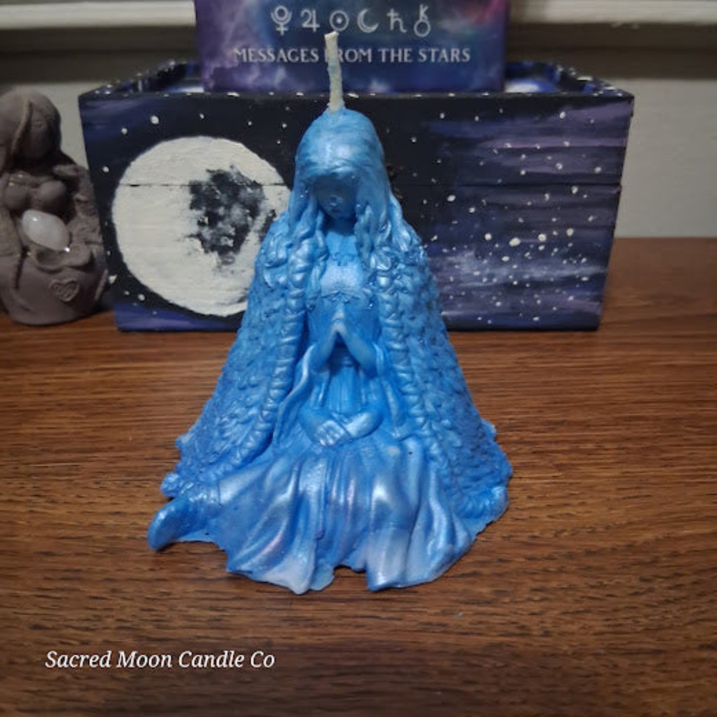 Sacred Moon Candle Co Blue Whispering Water Lily Goddess Candle 3.3oz . blue sculpted goddess candle on wood with star box