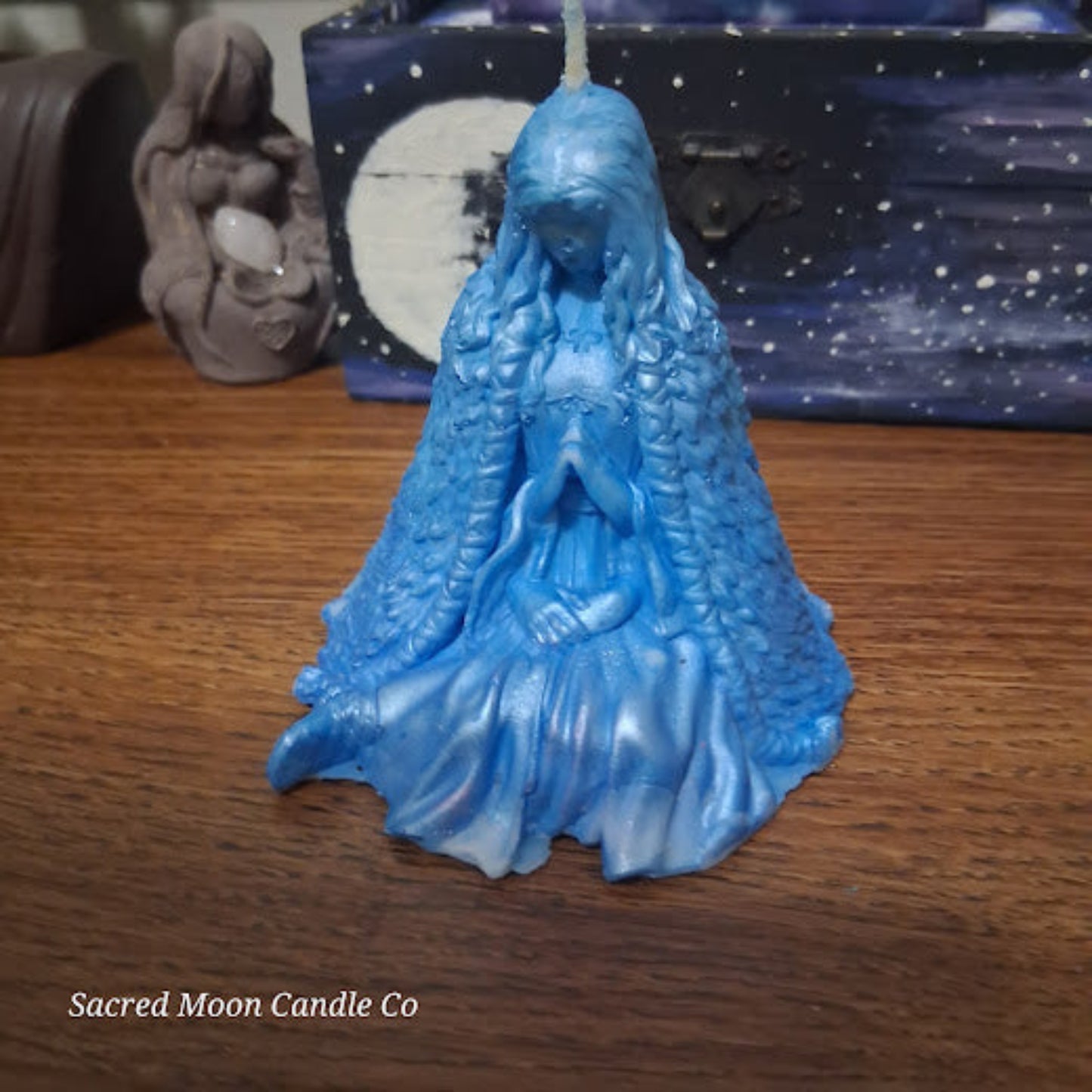 Blue Whispering Water Lily Goddess Candle 3.3oz . Sacred Moon Candle Co blue goddess candle on wood with petal cloak detail