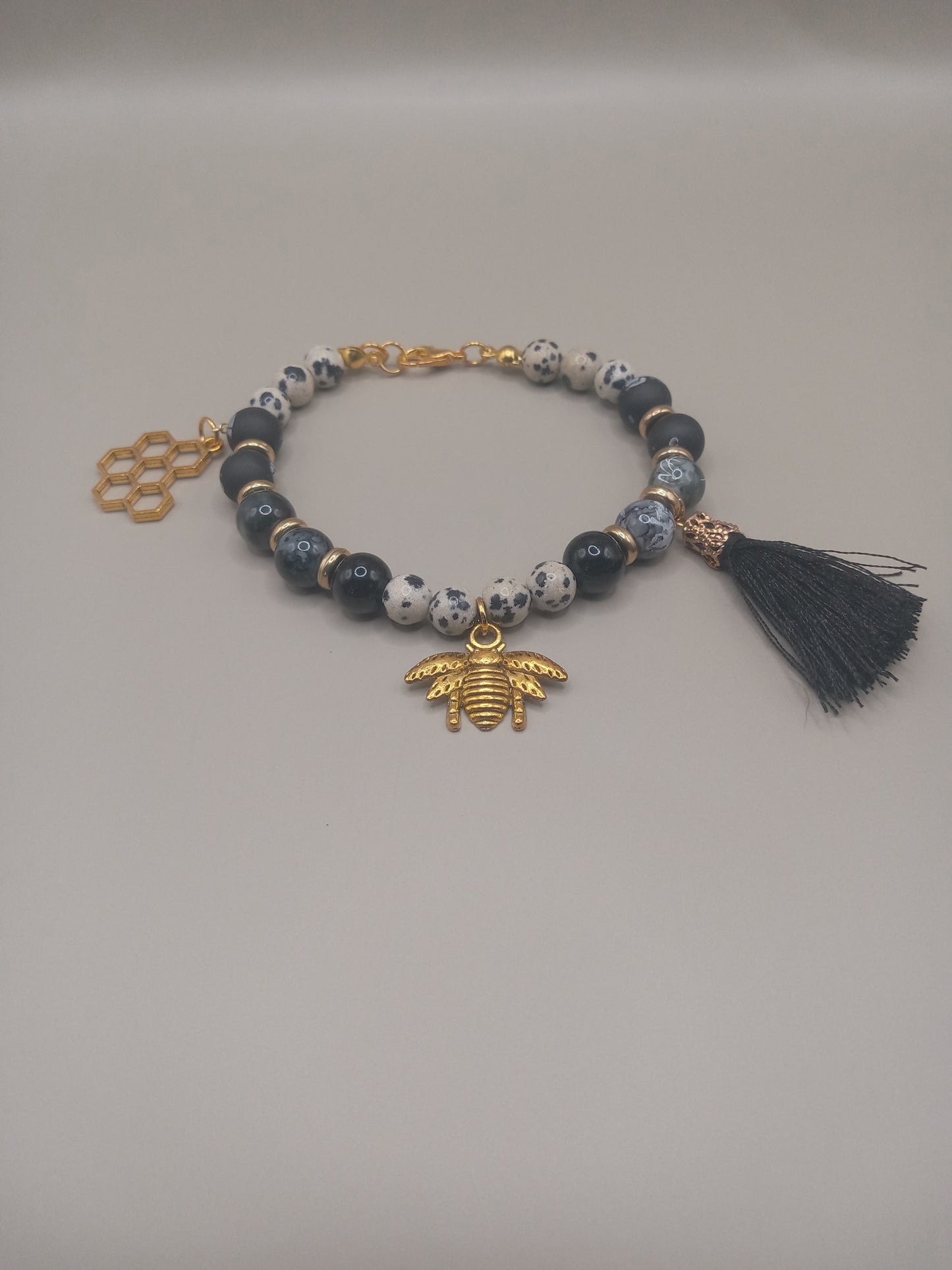 One with Nature Bohemian Dalmatian Jasper Bracelet Stack with gold bee charm honeycomb tag and black tassel