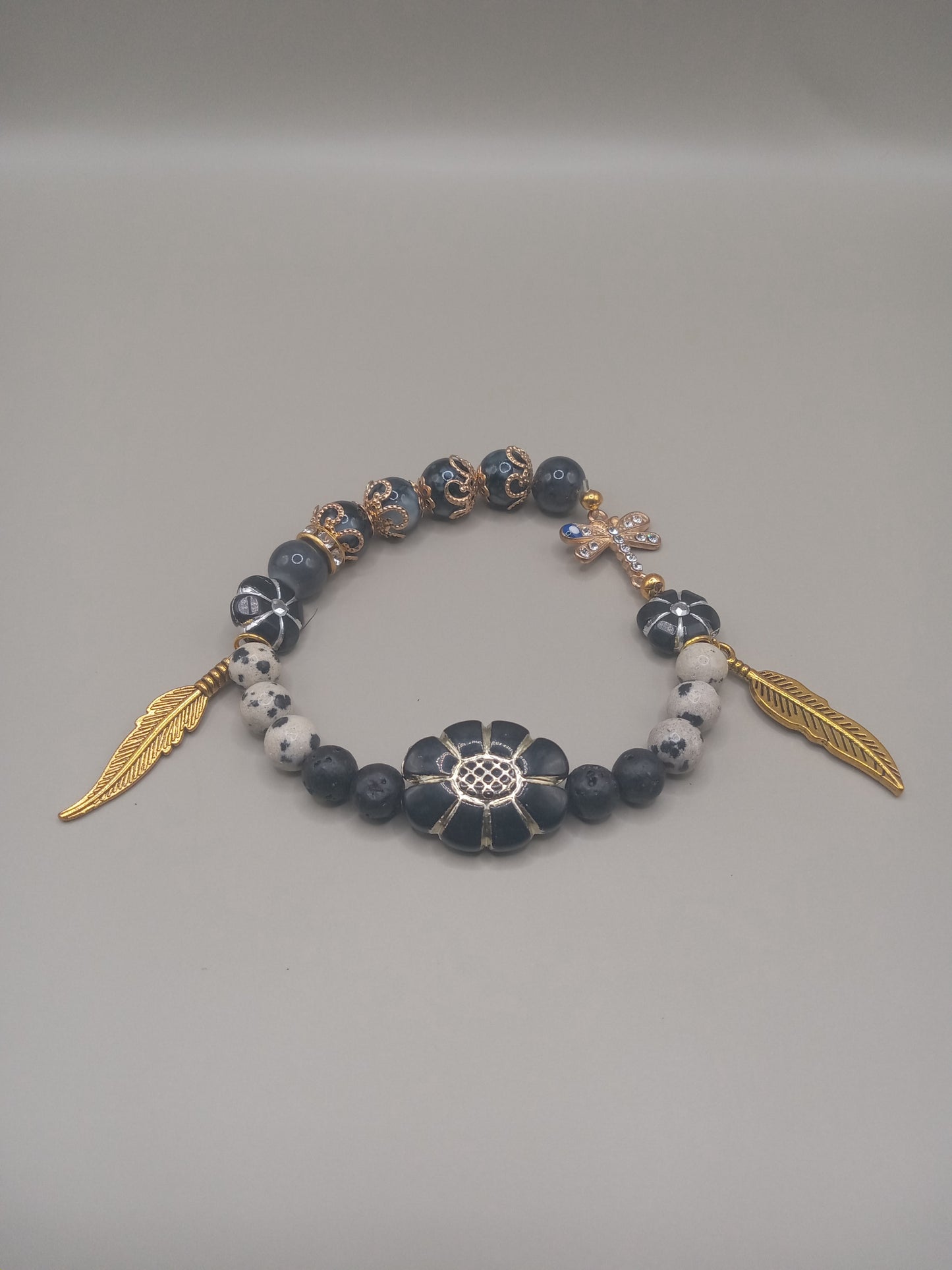 Sacred Moon Candle Co One with Nature Bohemian Dalmatian Jasper Bracelet Stack with gold feather charms and spotted jasper beads