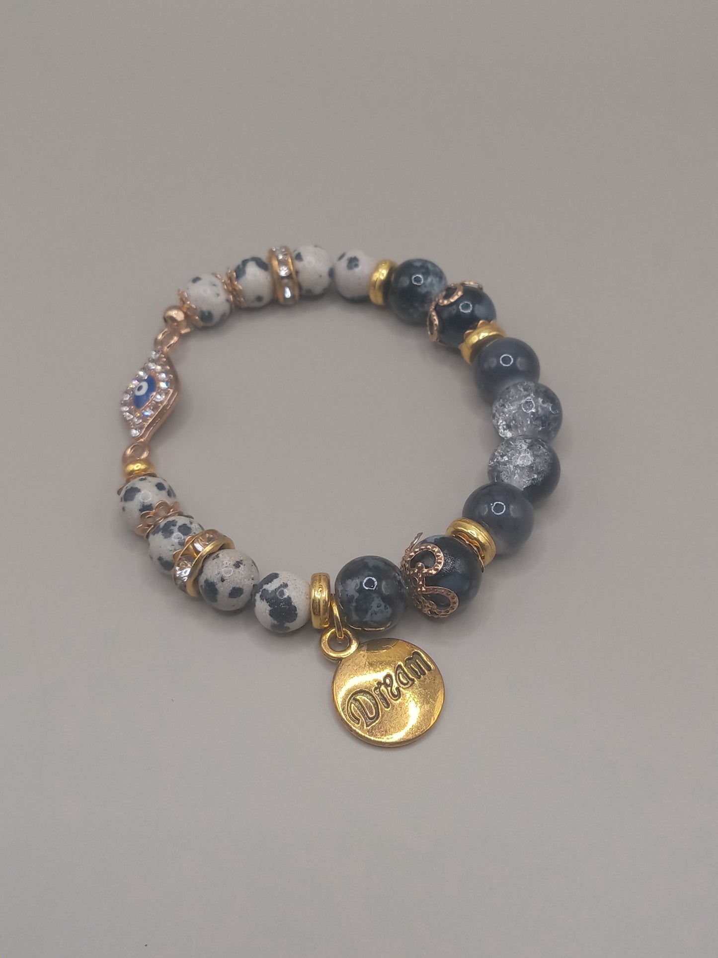 One with Nature Bohemian Dalmatian Jasper Bracelet Stack by Sacred Moon Candle Co with gray jasper beads and gold Dream charm