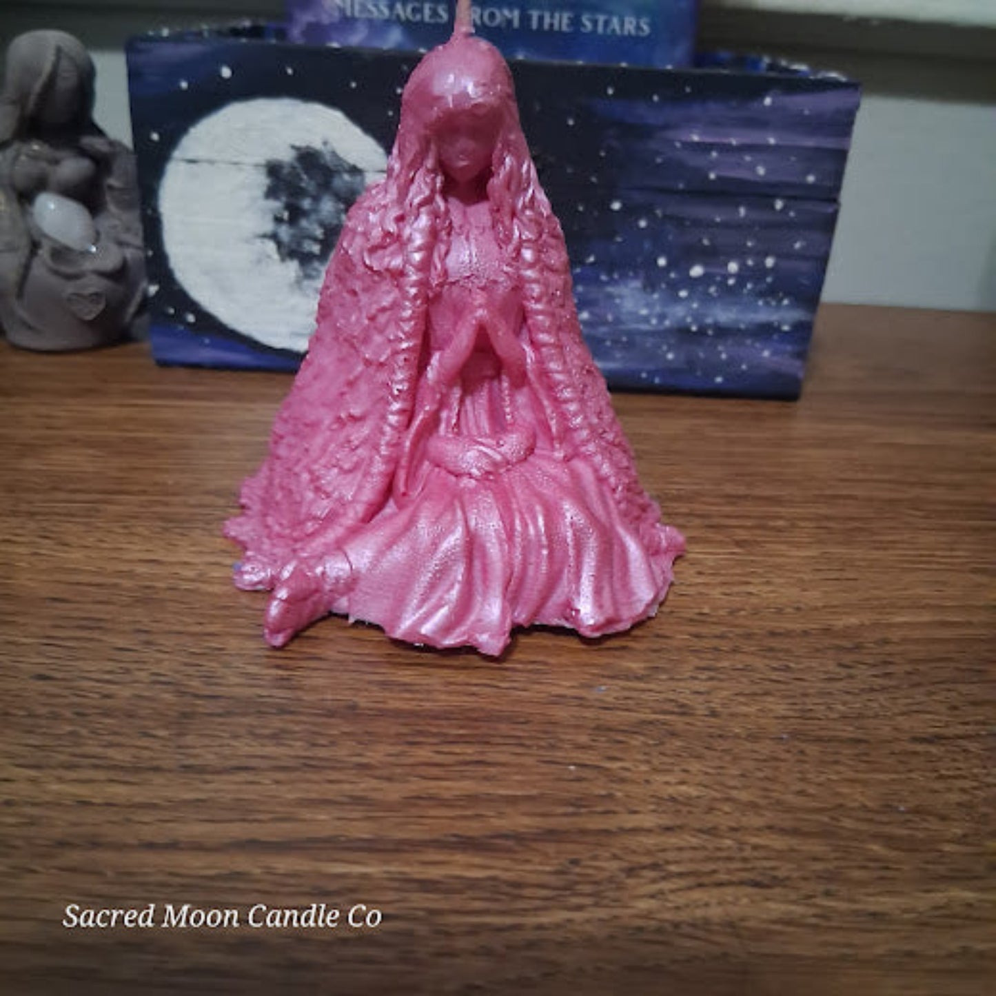 Pink carved goddess candle with praying hands on wooden altar pink water lily goddess candle for altar soy beeswax blend