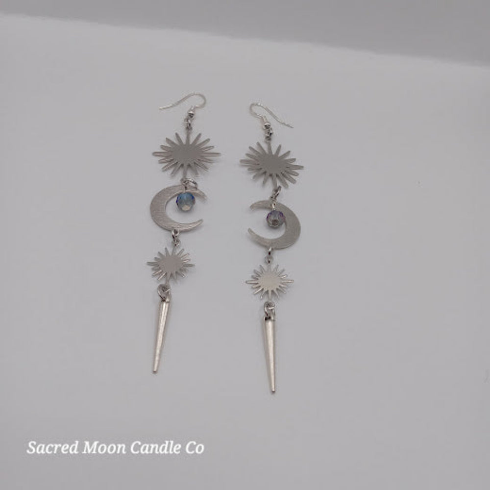 Sacred Moon Candle Co spiked moon dangle earrings with crescent moon and sunburst design in silver