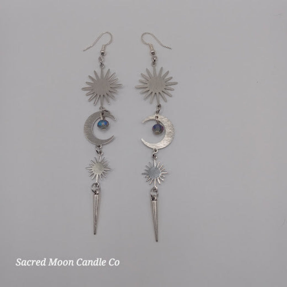 Silver spiked moon dangle earrings with crescent moons and sunburst charms by Sacred Moon Candle Co