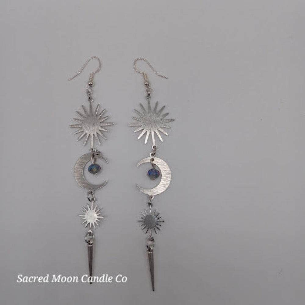 Silver spiked moon dangle earrings featuring celestial sun and moon charms with blue accent beads