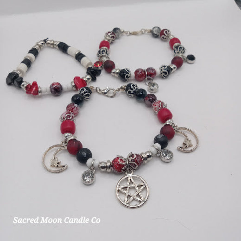 Triple Moon Goddess pentacle charm bracelet set by Sacred Moon Candle Co with red black beads and silver charms