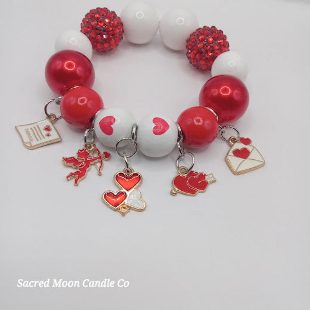 Cupid themed bubblegum beaded bracelet with red white beads and heart charms by Sacred Moon Candle Co