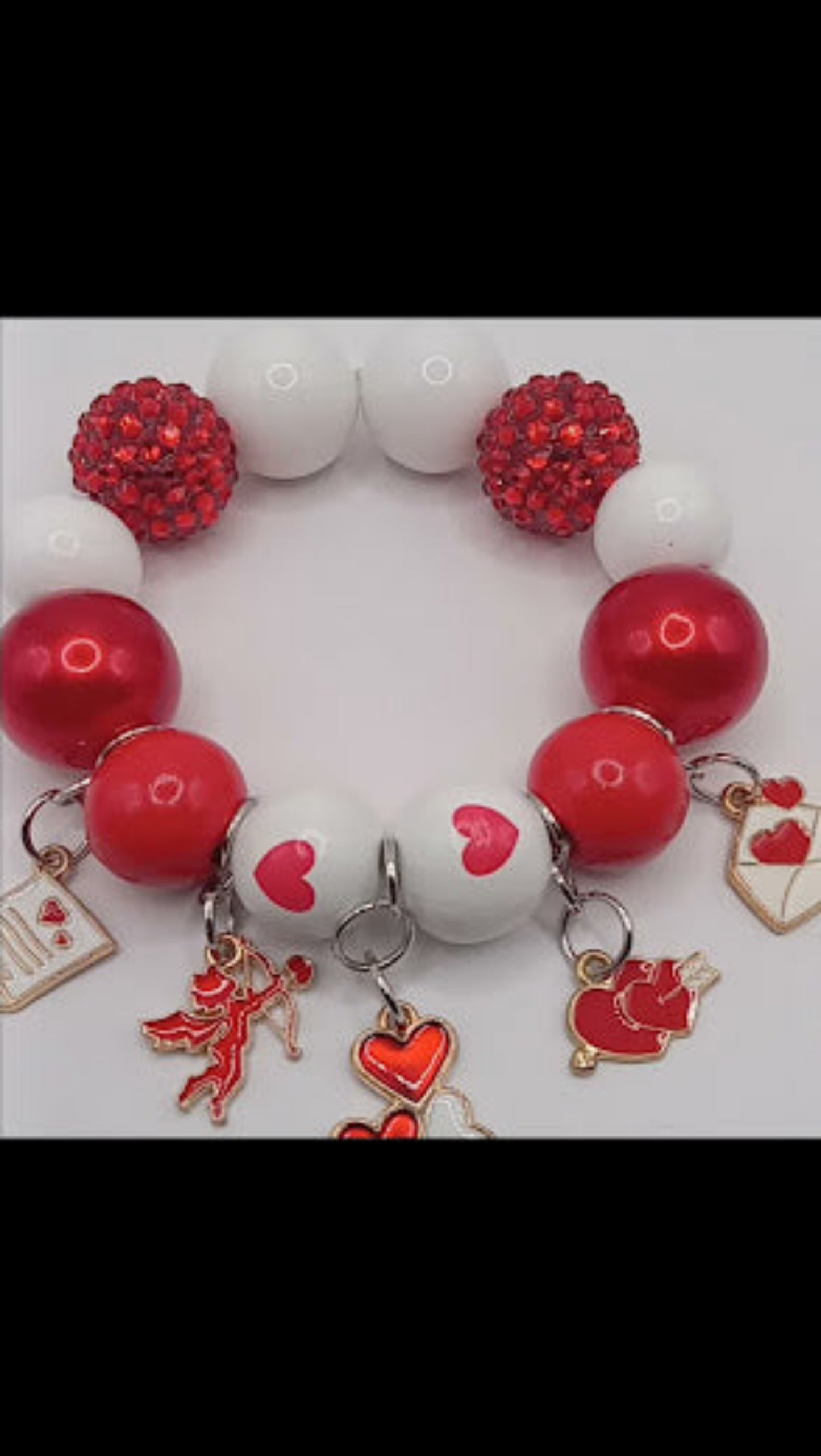 Cupid themed bubblegum beaded bracelet by Sacred Moon Candle Co with red white beads and heart charms