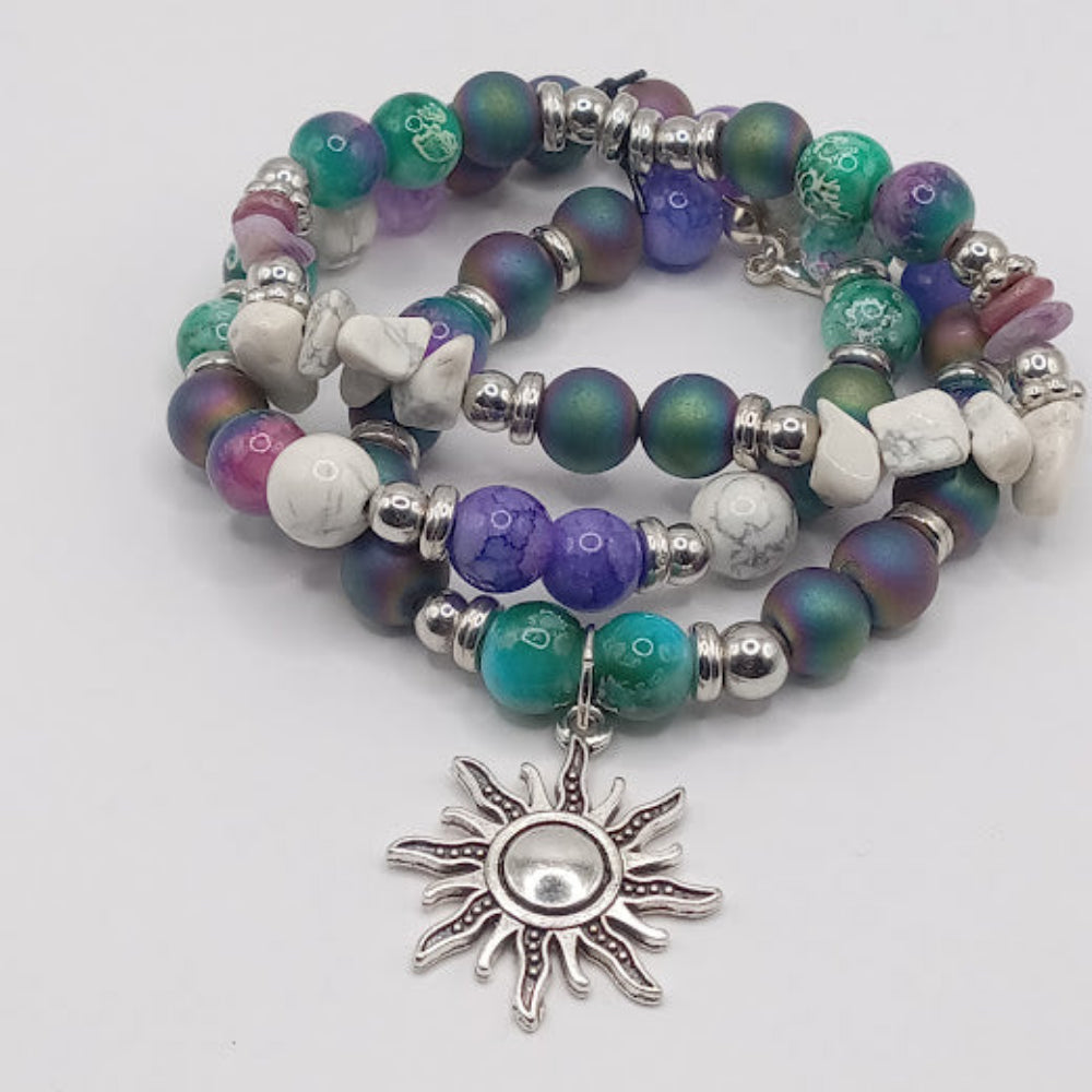 Celestial sun bracelet stack from Sacred Moon Candle Co with colorful beads and silver sun charm