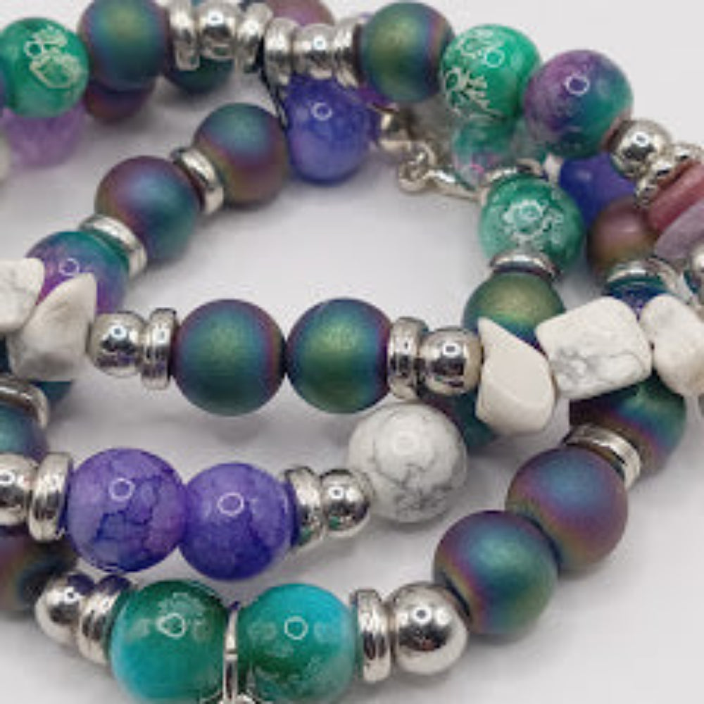 Sacred Moon Candle Co celestial sun bracelet stack featuring multicolored beads with silver accents