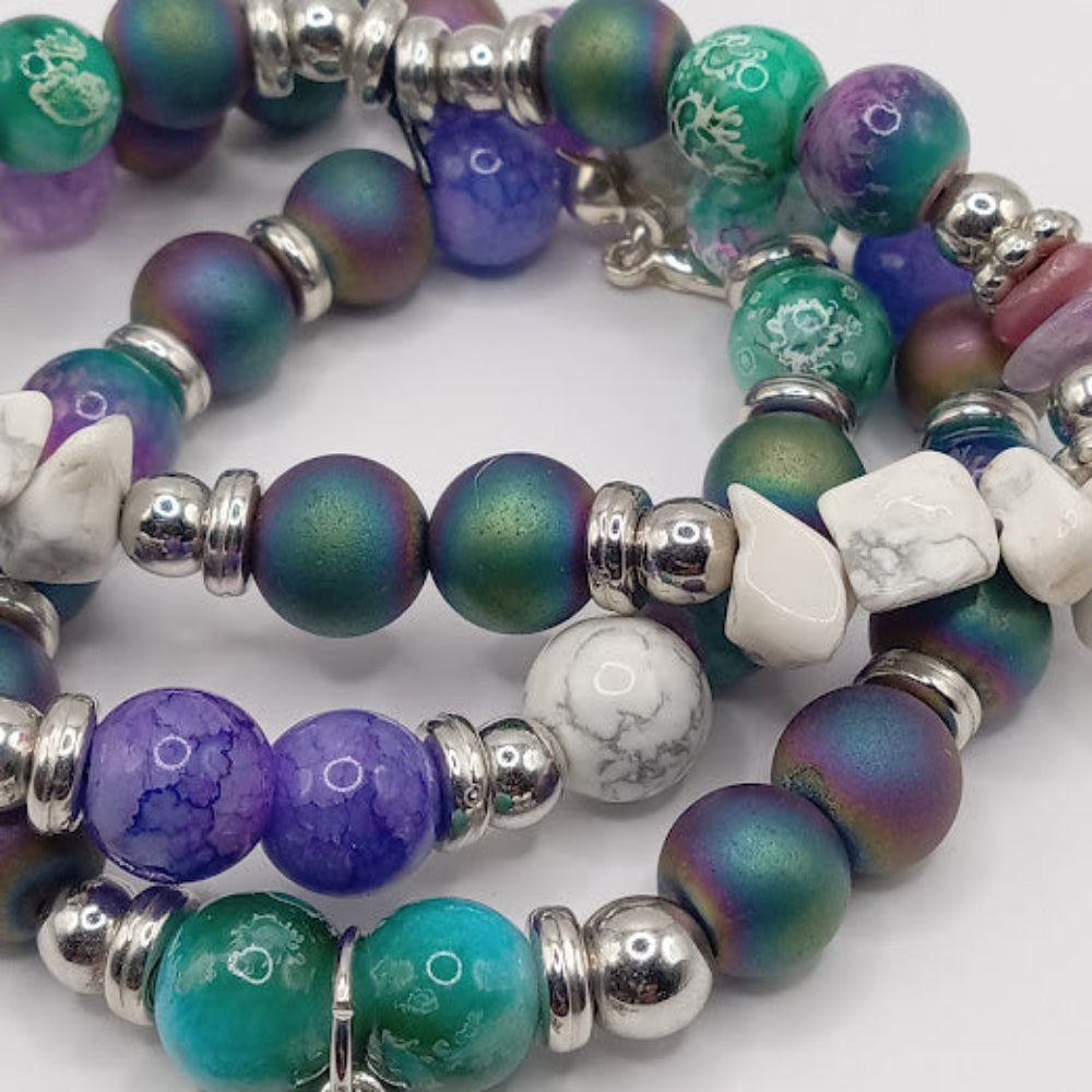 Celestial sun bracelet stack with multicolored beads and silver accents from Sacred Moon Candle Co