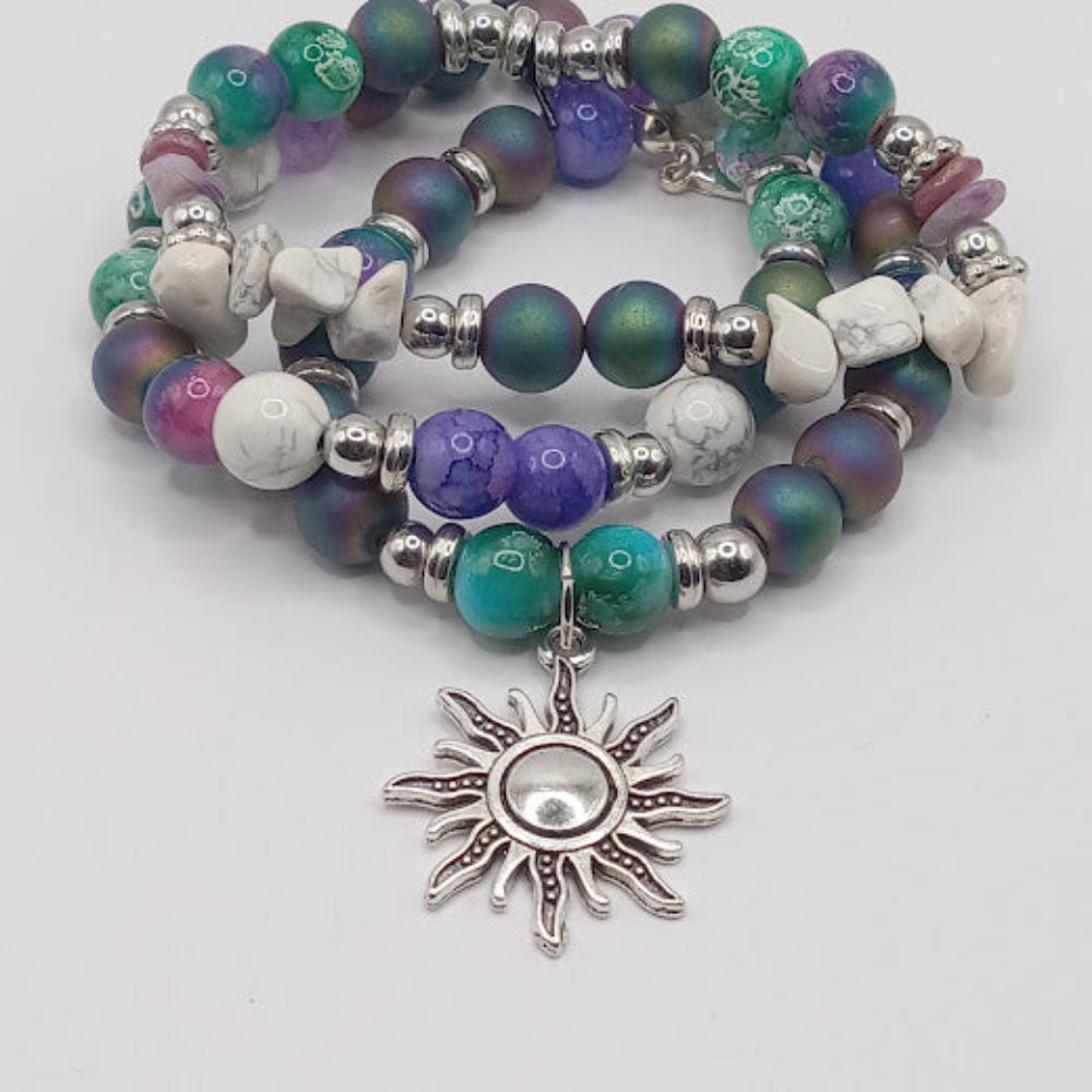 Celestial sun bracelet stack from Sacred Moon Candle Co with multicolored beads and sun charm