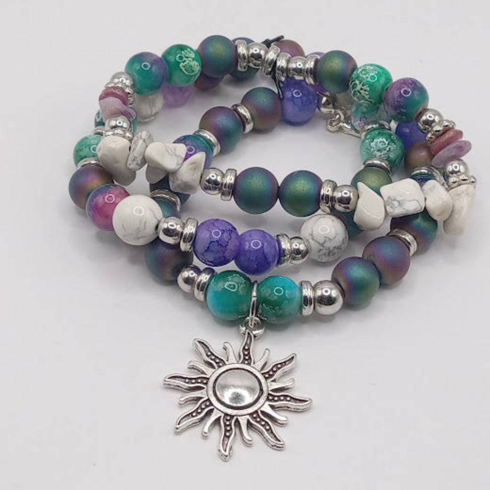 Celestial sun bracelet stack with colorful beads and silver sun charm from Sacred Moon Candle Co