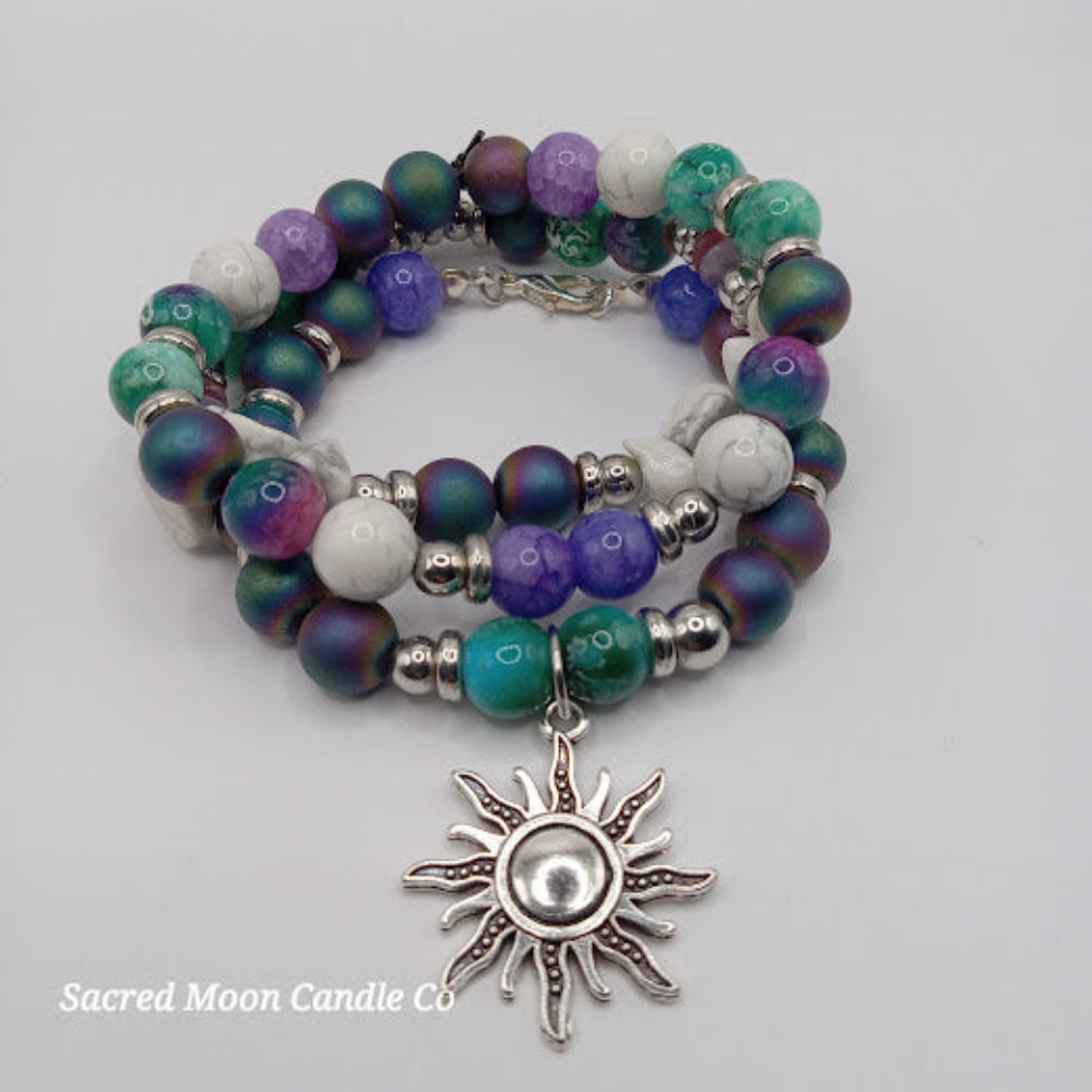 Colorful celestial sun bracelet stack with purple green white beads and silver sun charm from Sacred Moon Candle Co