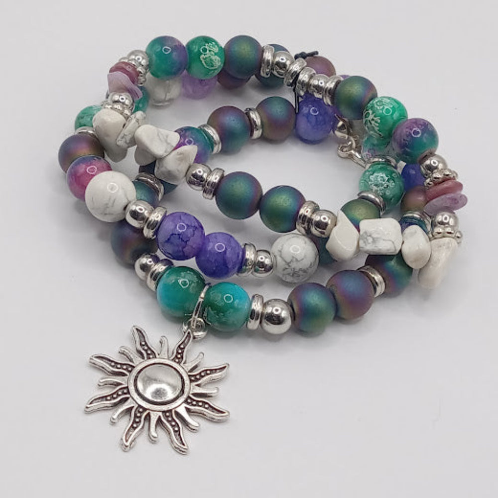 Celestial sun bracelet stack by Sacred Moon Candle Co with colorful beads and silver sun charm