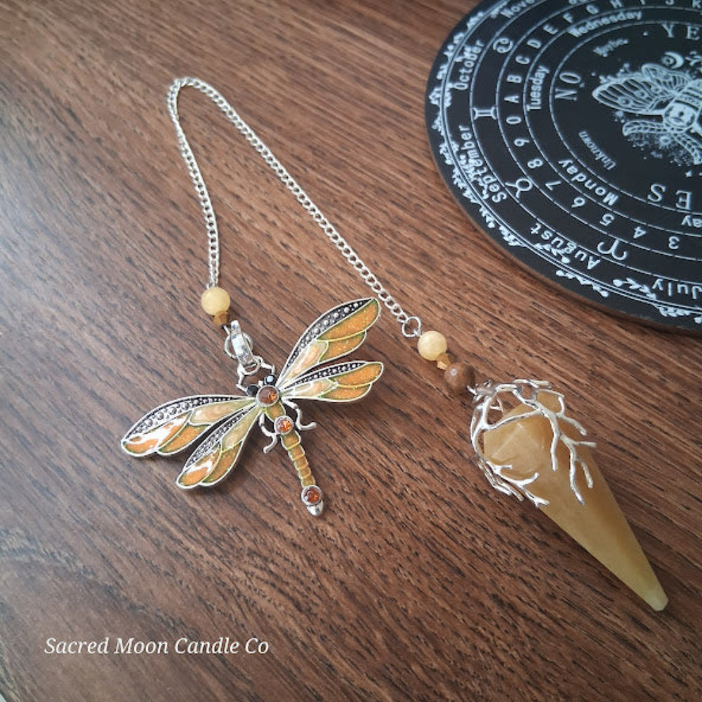 Golden healer quartz pendulum with dragonfly charm on silver chain from Sacred Moon Candle Co altar tools