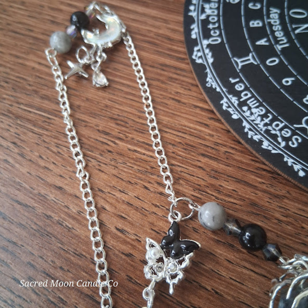 Larvikite moon pendulum altar tool with silver chain and decorative charms by Sacred Moon Candle Co